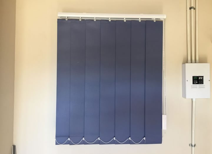 The 90 mm Vertical Commercial blind was installed at Qua Qua Clinic. It shows the aluminium headrail and cord that operates the blind. It totally blocks the sunlight and view when it is drawn closed.